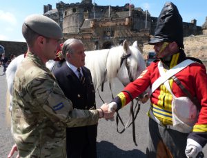 Brigadier Mel Jameson, chairman of the Royal Scots Dragoon Guards, and Sergeant Keith Mitchell, meet the 'ghost' of Scottish Waterloo hero Sgt Charles Ewart (played by former Royal Scots Dragoon Guards trooper Paul Martin) at Edinburgh Castle.