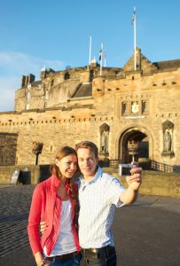Visitors take a selfie outside Edinburgh Castle