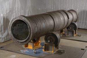 Image of cannon Mons Meg's after conservation and prior new painting treatment applied under HS Collections department supervision.