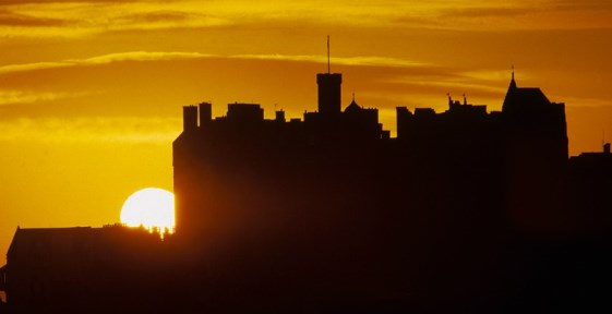 Photograph of Edinburgh Castle with a setting sun in the background