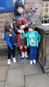 Children and bagpiper Outside the Royal Scots Dragoon Guards Regimental Museum