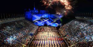 The tattoo celebrations at night in front of Edinburgh Castle lit up in the Scottish colours