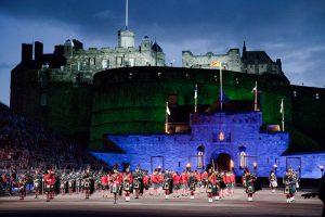 A lit up Edinburgh Castle behind tattoo celebrations