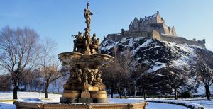 Edinburgh Castle and fountain in princess street gardens with snow