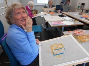 A member of the Heritage Sewing Group working on a panel