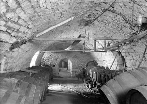 black and white image of a cellar with a curved ceiling