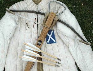 jacket with bow and arrows laid out on it