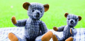 Edinburgh Castle tweed teddy bears on a tweed rug on the grass
