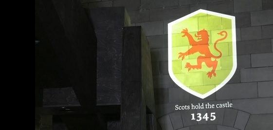 A lion rampant projected onto the wall of the exhibition room
