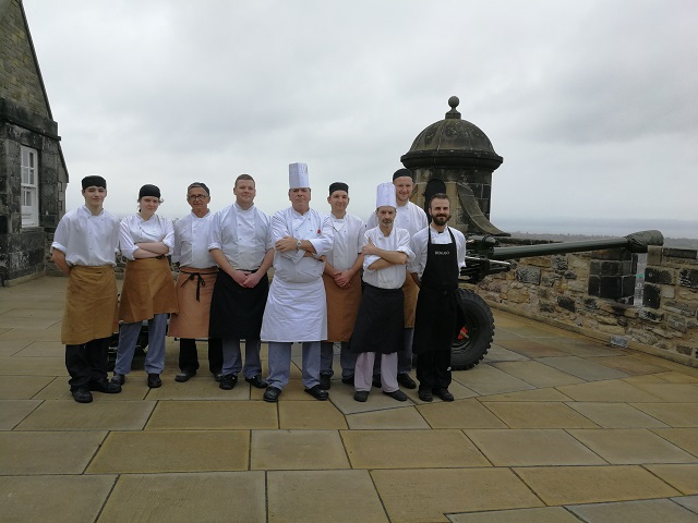 A team of chefs posing on the ramparts of Edinburgh castle 