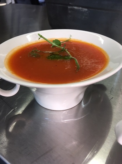 a bowl of red pepper and tomato soup