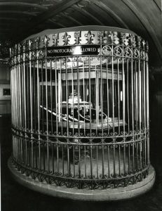 Archive image of the Crown Jewels. It is difficult to see the objects because cast iron railings obscure the view.