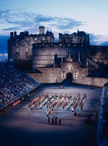 A view of Edinburgh Castle at twilight with performers in the centre of the esplanade