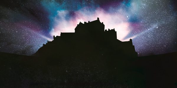 Silhouette of Edinburgh Castle with dramatic lighting emitting from within