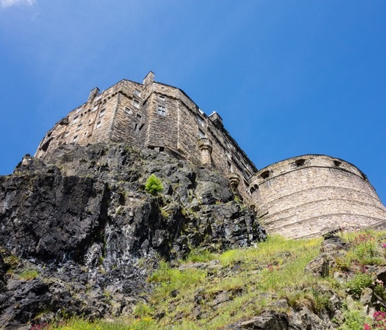 Low angle view of Edinburgh Castle taken from the bottom of Castle Rock. It looks towering and imposing.