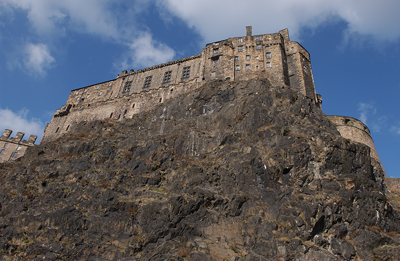 View up the sheer face of Edinburgh Castle Rock from the Grassmarket area of town.