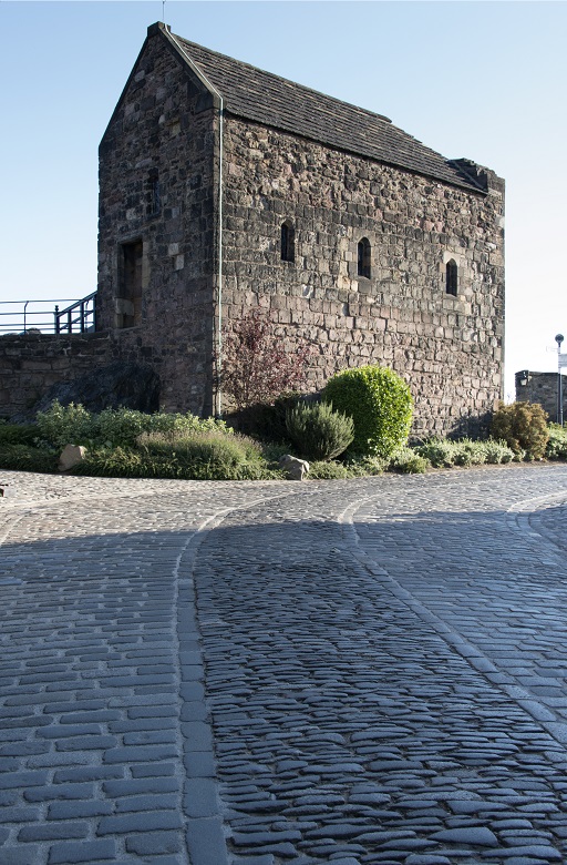 A stone path leading to a small and humble chapel b