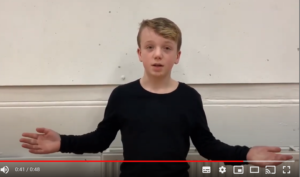 A screengrab of a boy presenting a YouTube video