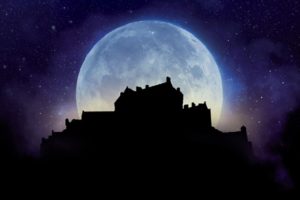 An artist's impression of a huge full moon behind the silhouette of Edinburgh Castle