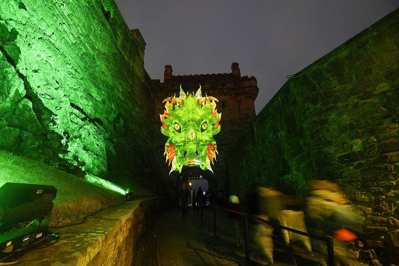 A projection of a green dragon above a gate at Edinburgh Castle