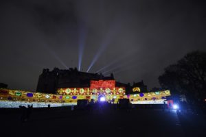 The front of Edinburgh Castle covered in spectacular, colourful projections