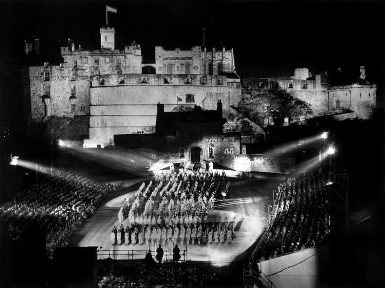 A black and white archive photo of the military tattoo taking place in front of Edinburgh Castle