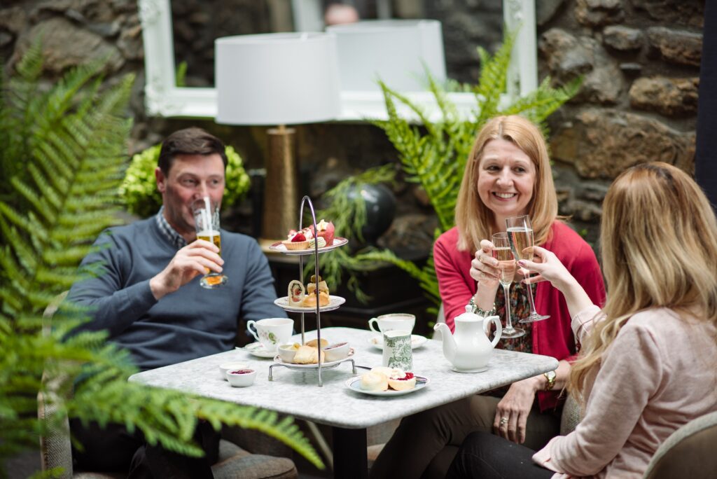 A group of people enjoying afternoon tea at Edinburgh Castle.