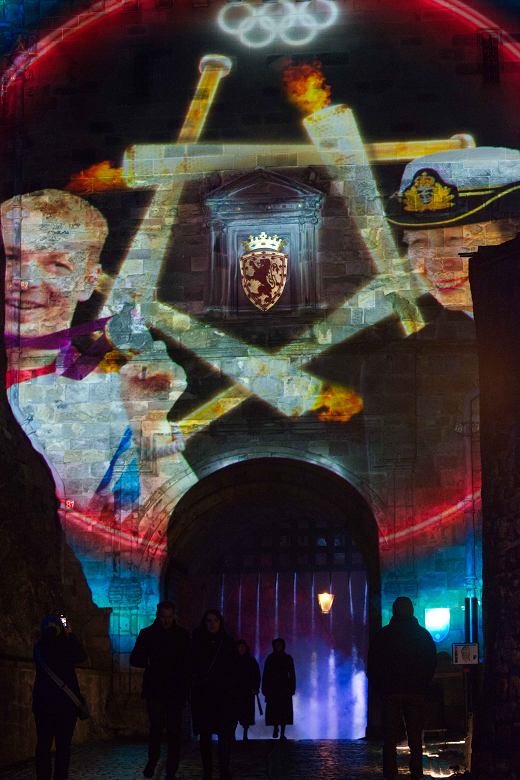 Visitors enter the Castle of Light event as dramatic projections illuminate the castle gates