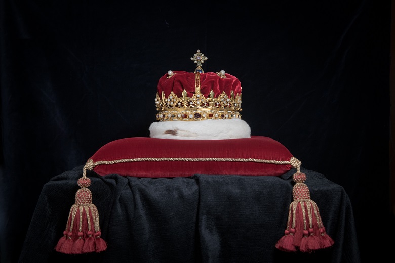 The crown of Scotland resting on a red velvet cushion