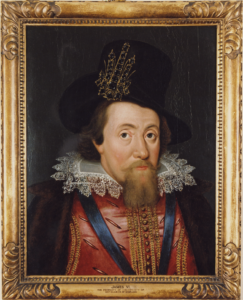 A portrait picture in a gold frame of a man with a beard in royal 16th century clothing. He looks directly out of the painting.